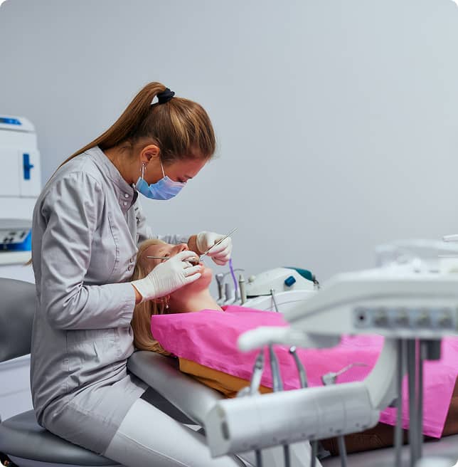 dentist using tools inside patient's mouth