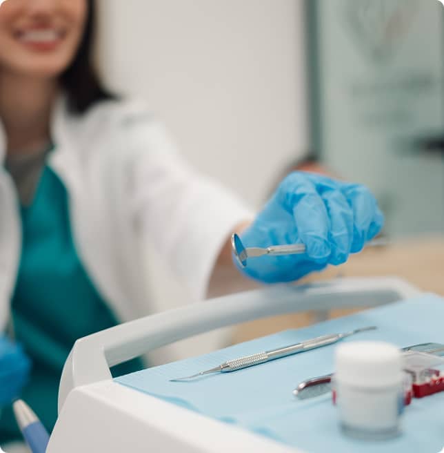 dentist picking up tool