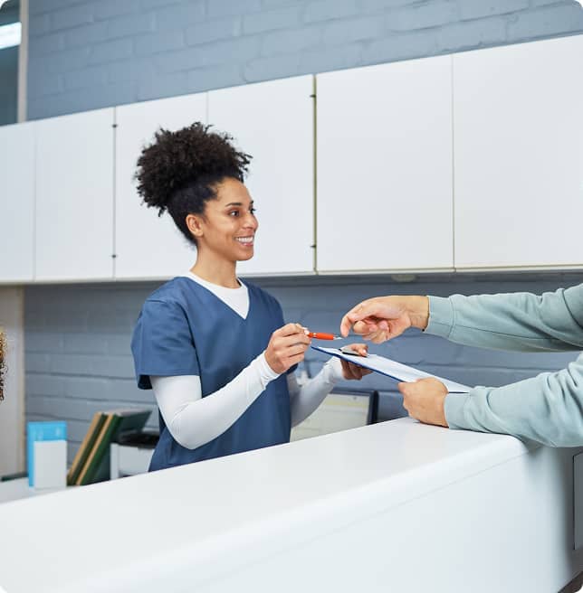 receptionist checking patient into dental office