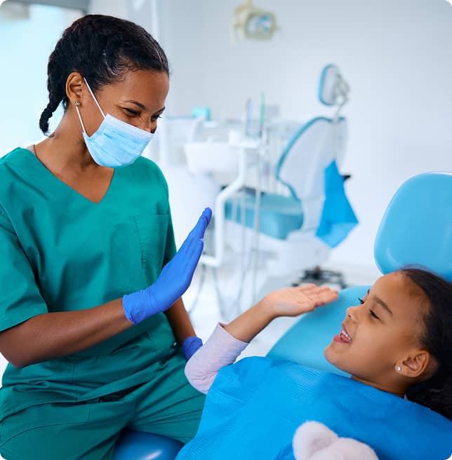 dentist high-fiving young patient