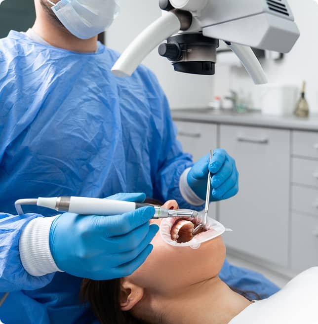 dental hygienist performing oral exam