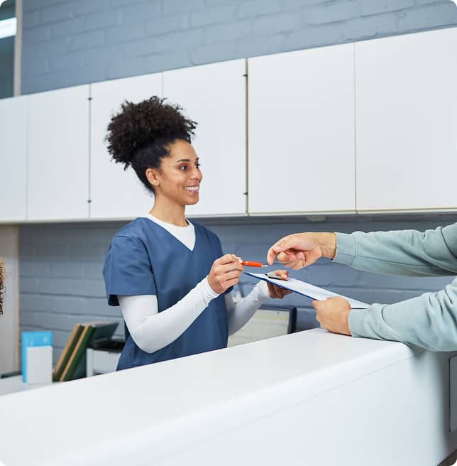 receptionist checking patient into dental office