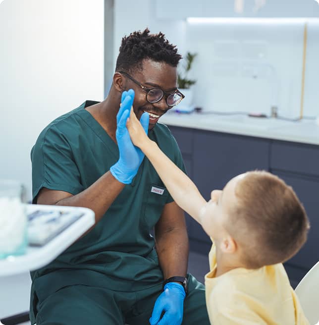 dentist high-fiving little boy