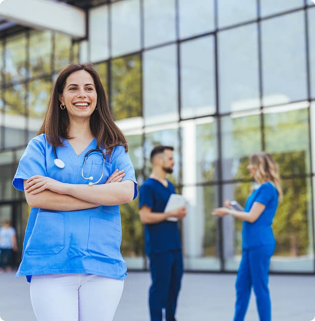 dentist outside office with two other dentists behind her in conversation