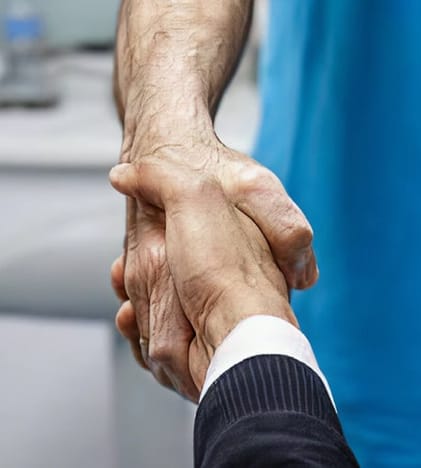 Business man shaking hands with a dentist